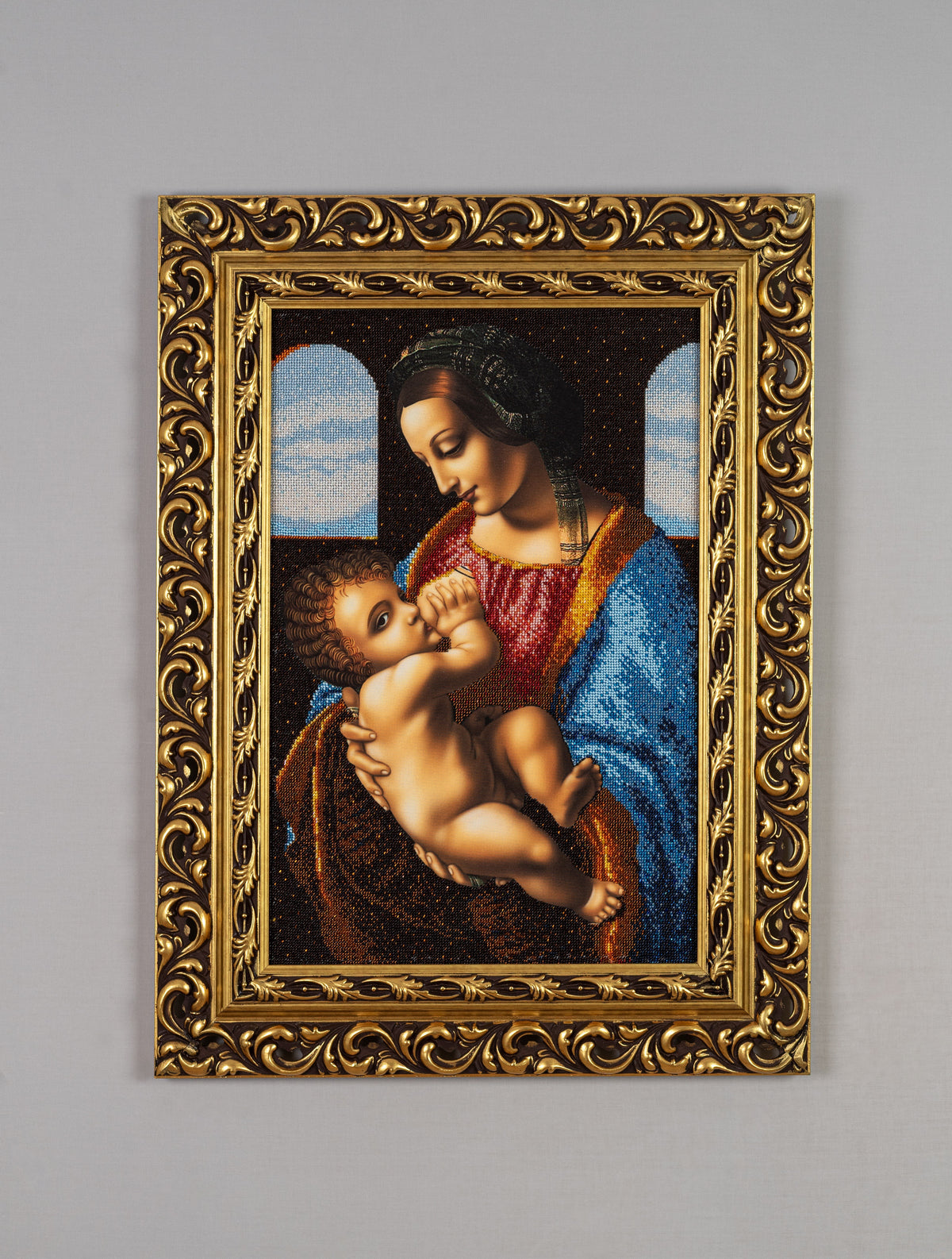 Full view of Madonna bead embroidery artwork showing the complete gold-leaf frame and proportions