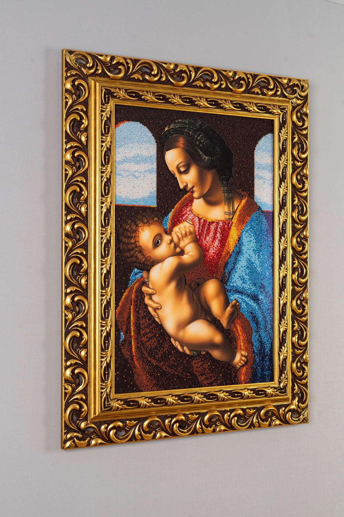 Side view of Madonna bead embroidery artwork showing the depth and ornate gold-leaf wooden frame
