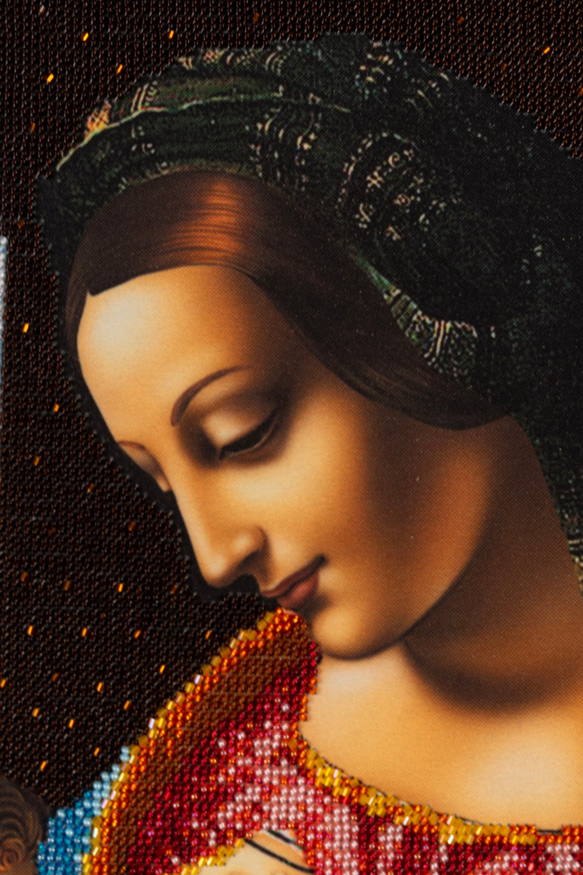 Close-up of Madonna in the Leonardo da Vinci inspired bead embroidery artwork, showing beadwork and facial detail