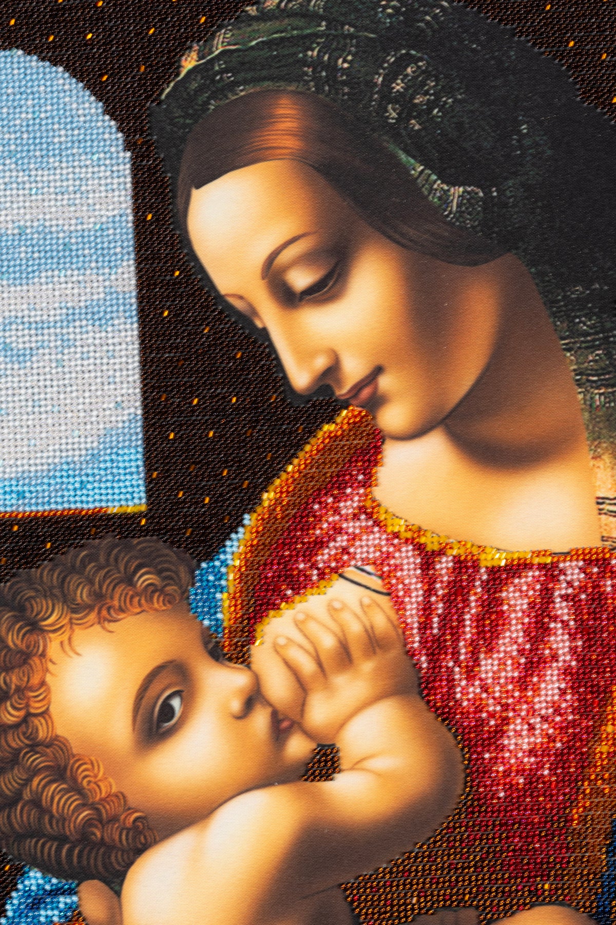 Close-up of Madonna and Child showing detailed hand bead embroidery and the reflective surface of Czech seed beads