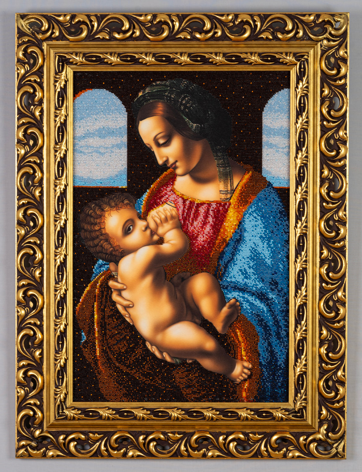 Front view of Madonna bead embroidery inspired by Leonardo da Vinci, framed in an ornate gold-leaf wooden frame