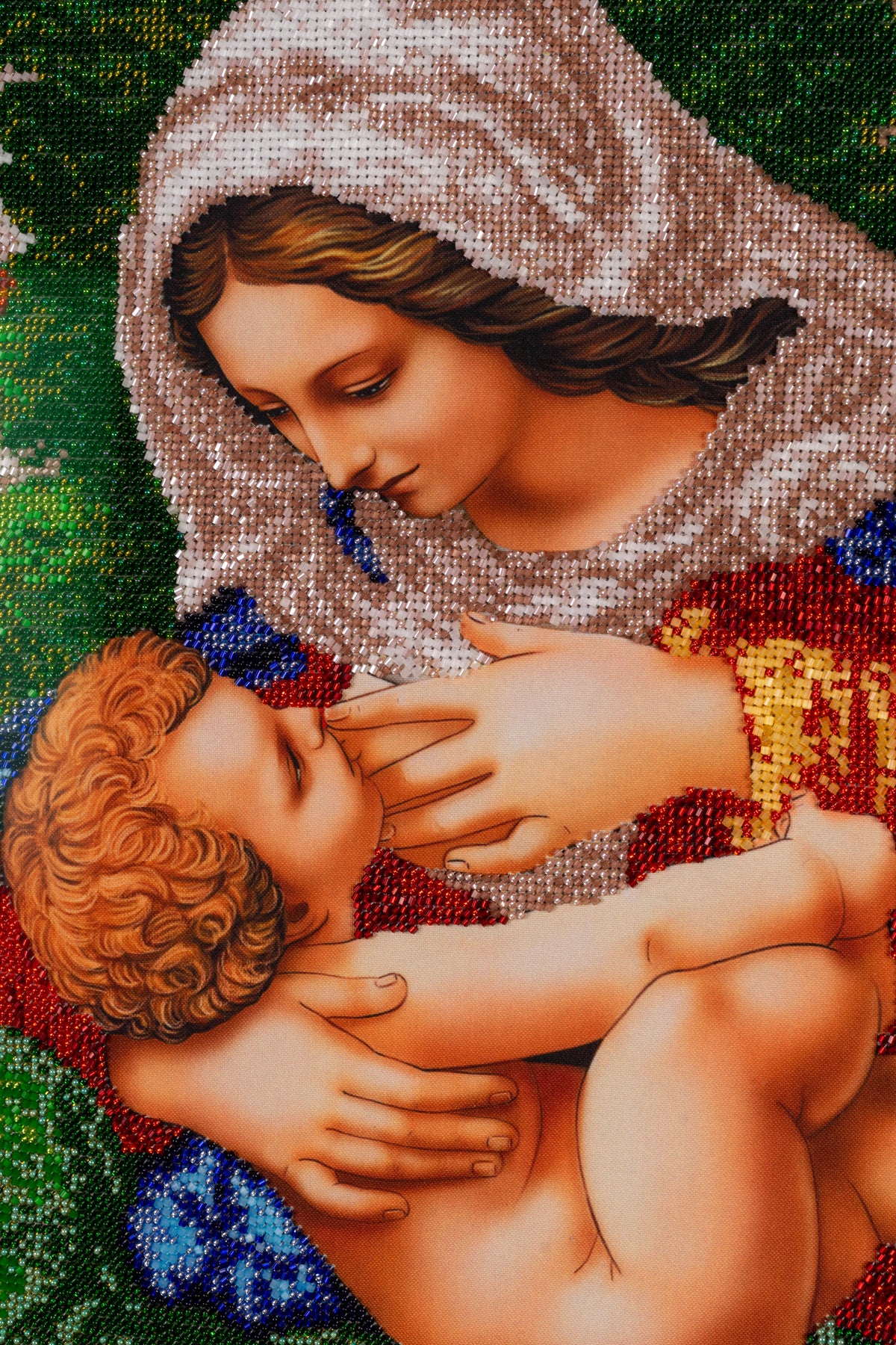 Detail of Madonna and Child showing hand-embroidered glass beadwork and figurative composition