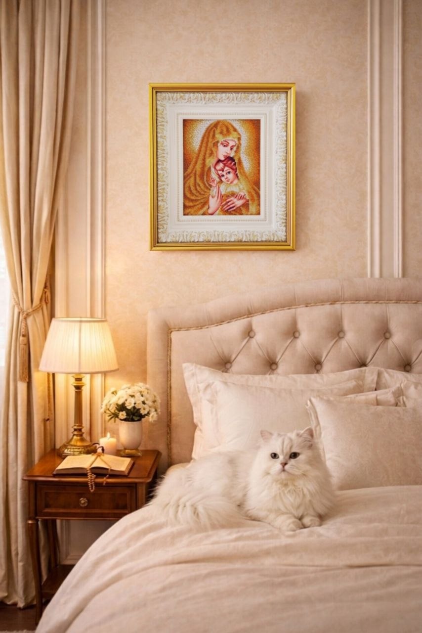 Gold Madonna displayed above a cream upholstered bed in an elegant neutral-toned bedroom.