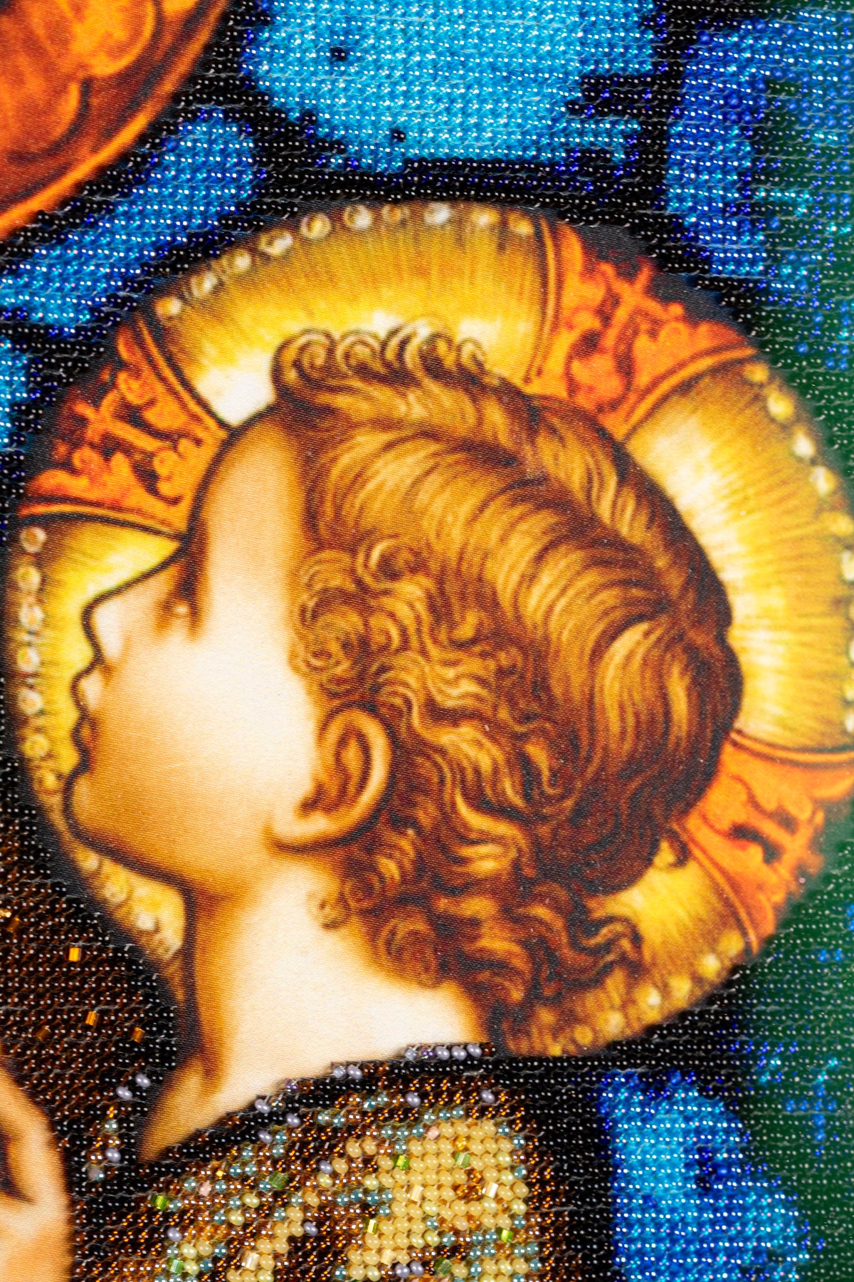 Close-up of the Child Jesus with golden halo, surrounded by blue and dark bead embroidery in St. Joseph & Jesus