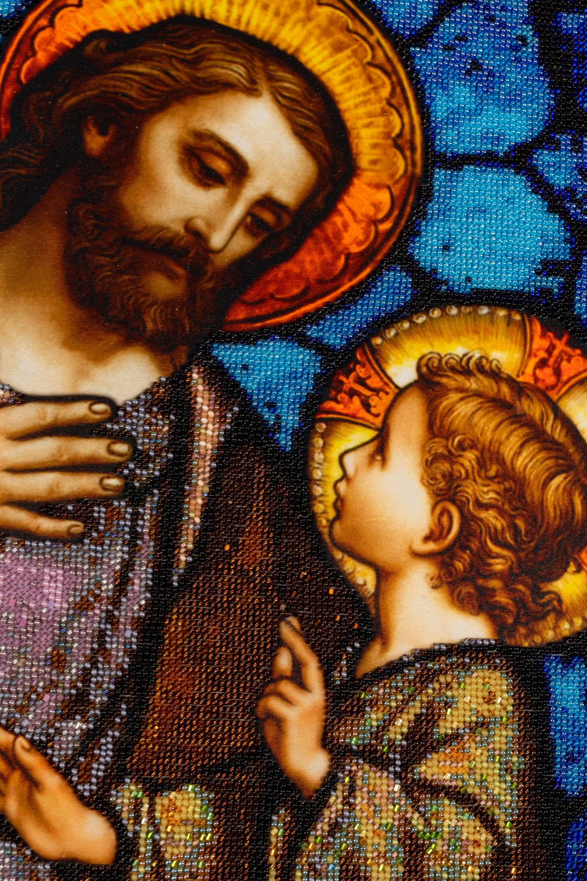 Detail of St. Joseph and the Child Jesus showing their faces, halos, gestures and intricate Czech seed bead embroidery