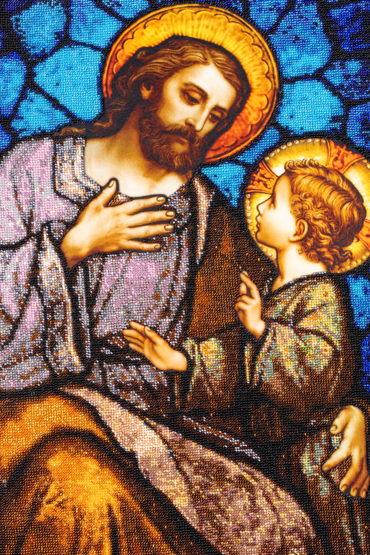 Close view of St. Joseph and the Child Jesus, revealing the detailed bead embroidery, luminous halos and blue background
