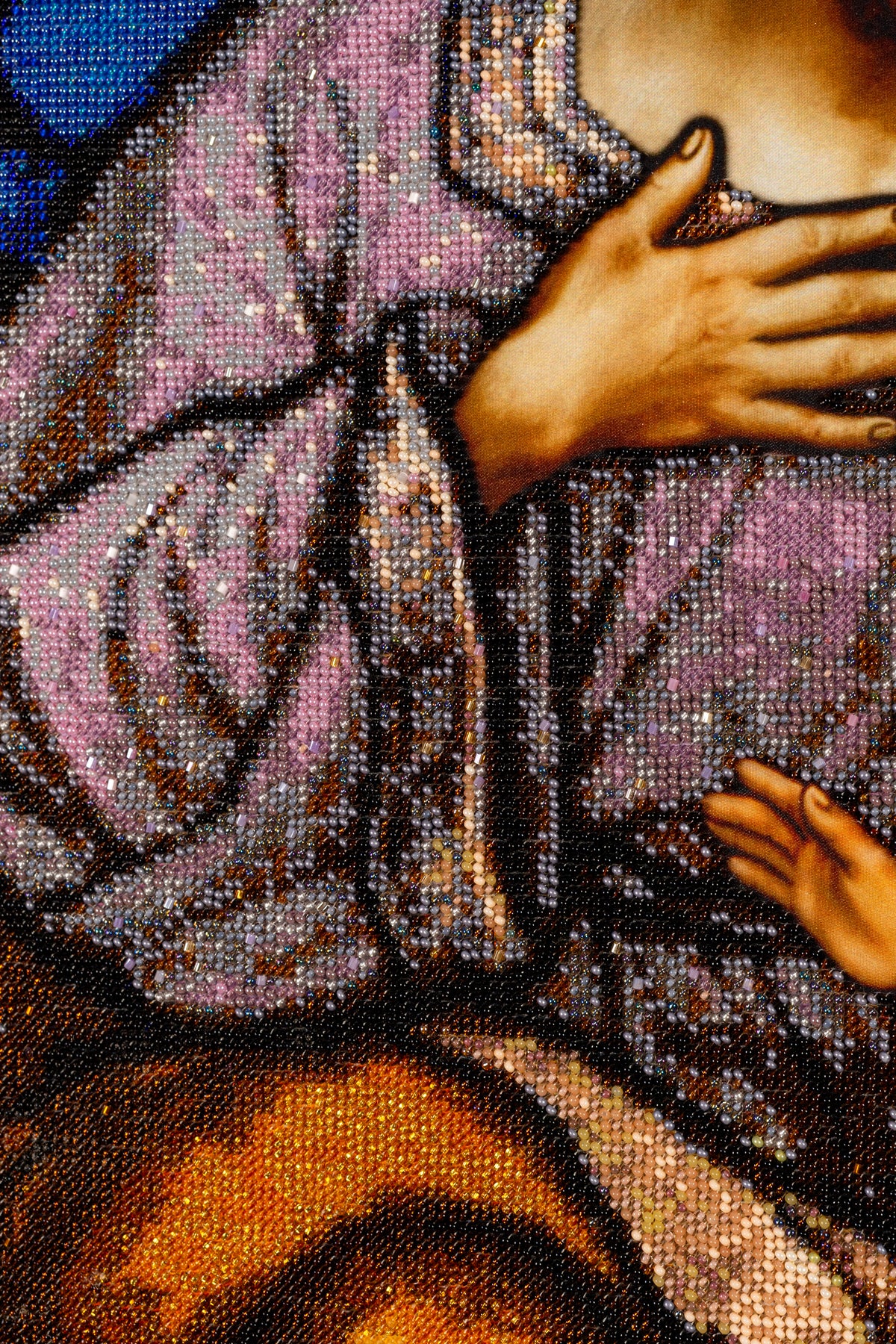 Detail of St. Joseph’s hand and robe in St. Joseph & Jesus, showing intricate hand embroidery with Czech PRECIOSA seed beads