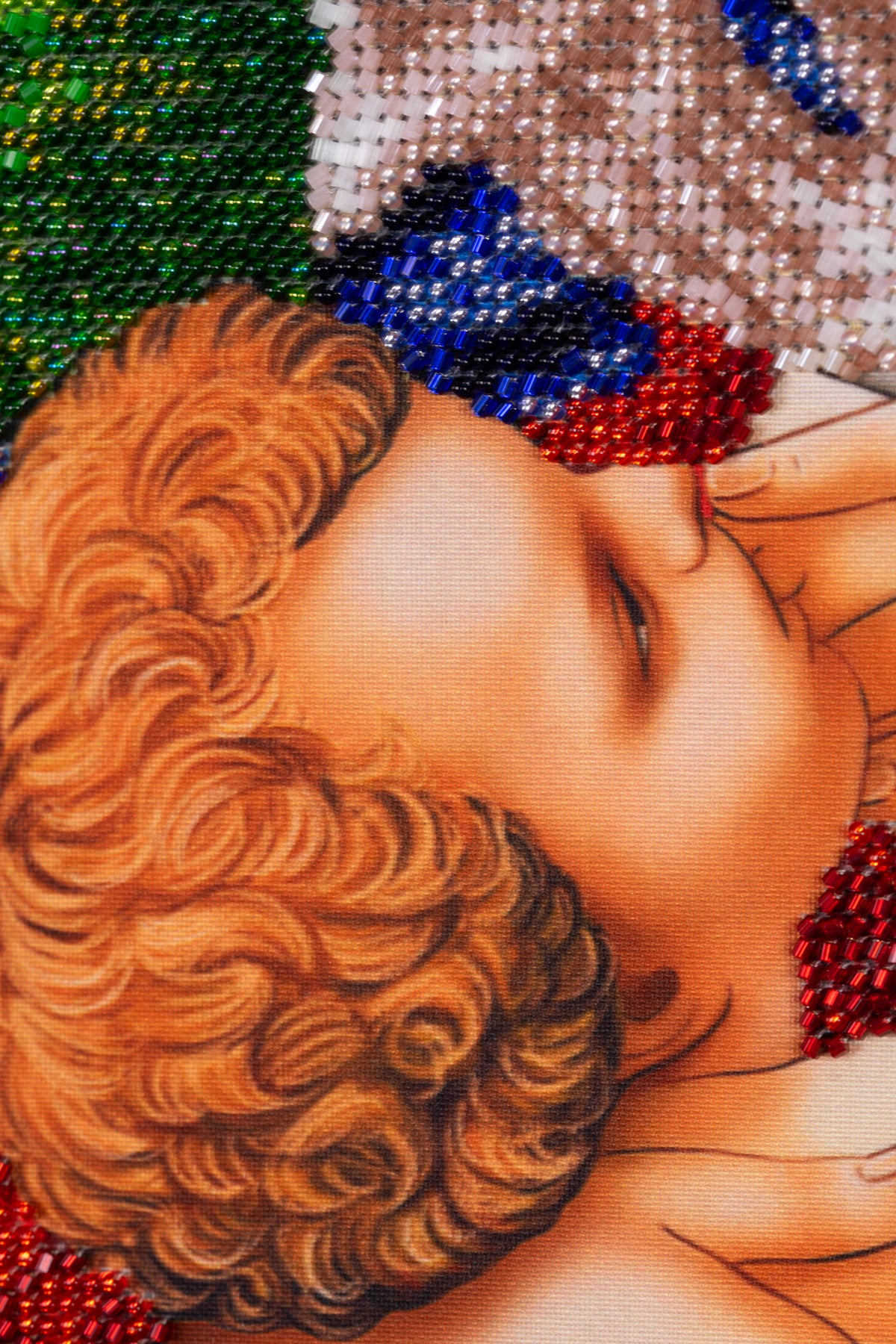 Macro detail of the Christ Child in Madonna and Child in the Garden bead embroidery