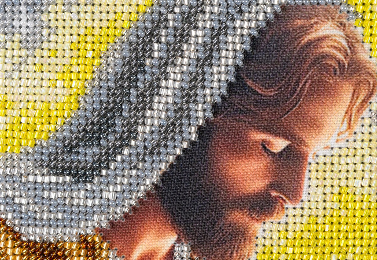 Macro detail of Joseph in Incarnation showing the texture and density of the bead embroidery