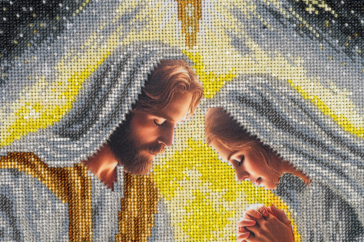 Detail of Mary and Joseph in Incarnation, surrounded by hand-embroidered silver, gold and yellow beads