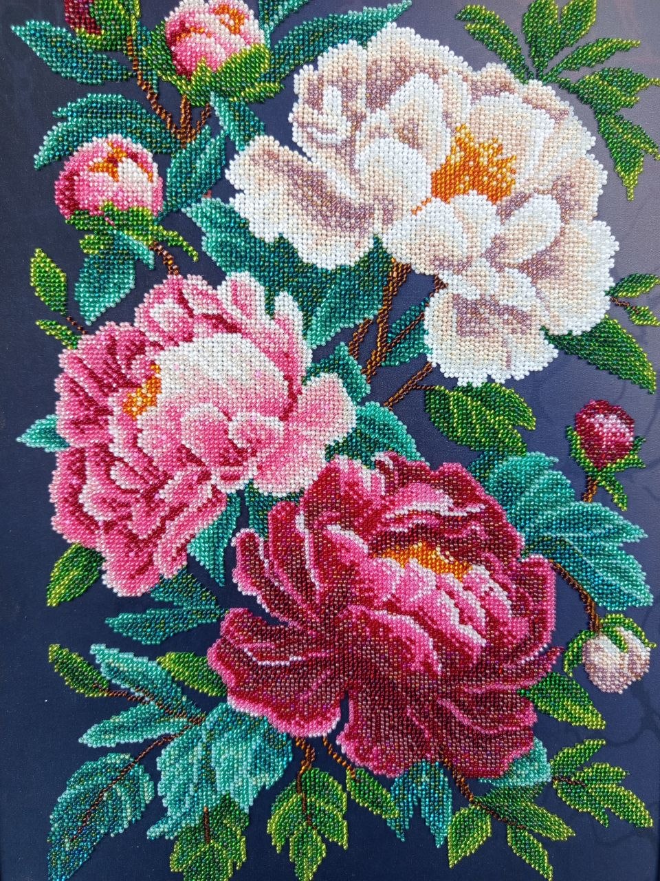Close-up of Peonies showing hand-applied glass beads forming pink, white and crimson flowers and green leaves